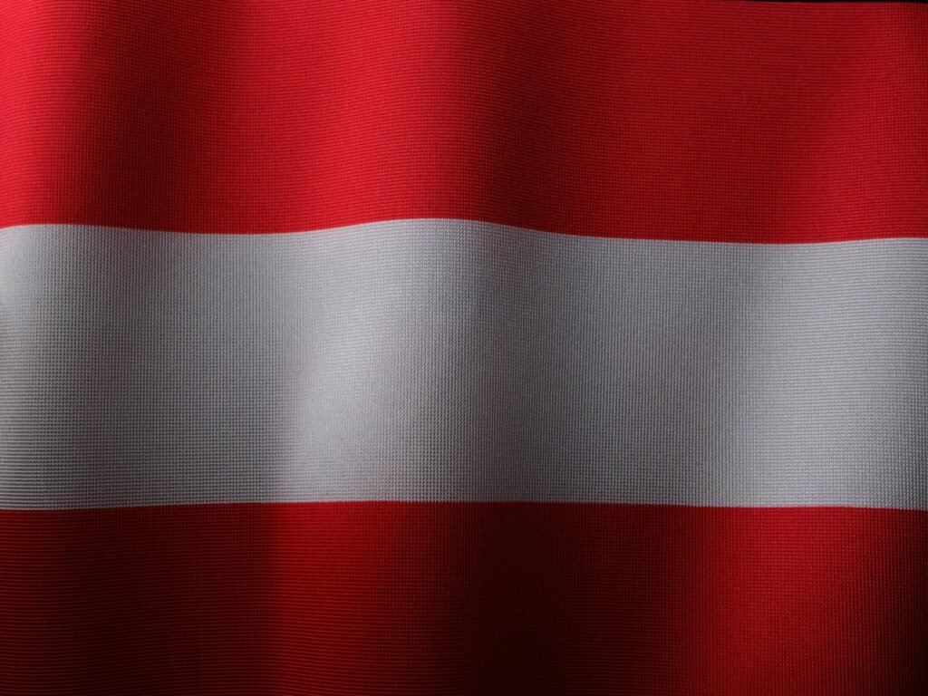 Close-up view of the Austrian flag showcasing texture and vibrant colors.