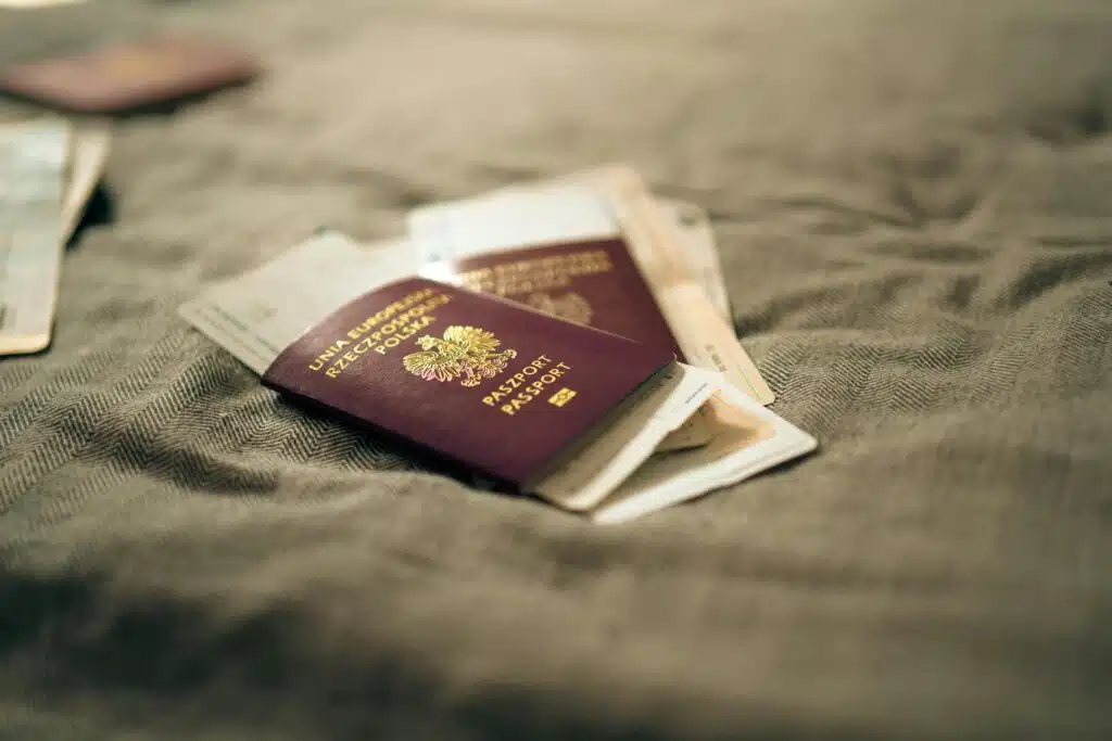 A close-up of a Polish passport and travel documents placed on a fabric surface, symbolizing travel and identity.